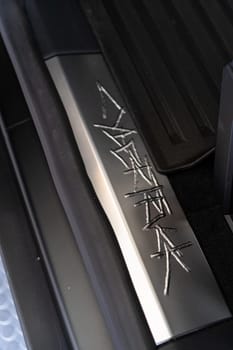 Denver, Colorado, USA-May 5, 2024-This image showcases the distinctive metal engraving of the Cybertruck logo on the interior of a Tesla Cybertruck, highlighting the vehicle unique branding elements and detailed craftsmanship.