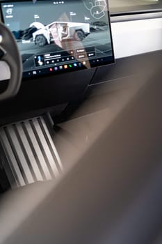 Denver, Colorado, USA-May 5, 2024-The interior of a Tesla Cybertruck showcasing its advanced touchscreen display, which is centrally located between the driver and passenger seats. This image highlights the modern design and technological features of the electric vehicle.