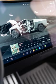 Denver, Colorado, USA-May 5, 2024-The interior of a Tesla Cybertruck showcasing its advanced touchscreen display, which is centrally located between the driver and passenger seats. This image highlights the modern design and technological features of the electric vehicle.