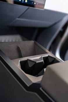 Denver, Colorado, USA-May 5, 2024-This image captures the innovative design of the cupholder inside the Tesla Cybertruck, showcasing its unique angular shapes and modern, minimalist aesthetic.