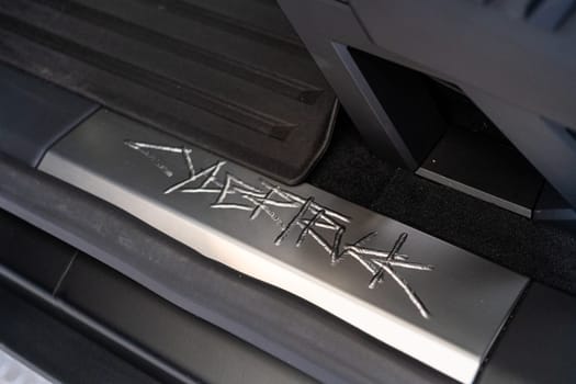 Denver, Colorado, USA-May 5, 2024-This image showcases the distinctive metal engraving of the Cybertruck logo on the interior of a Tesla Cybertruck, highlighting the vehicle unique branding elements and detailed craftsmanship.