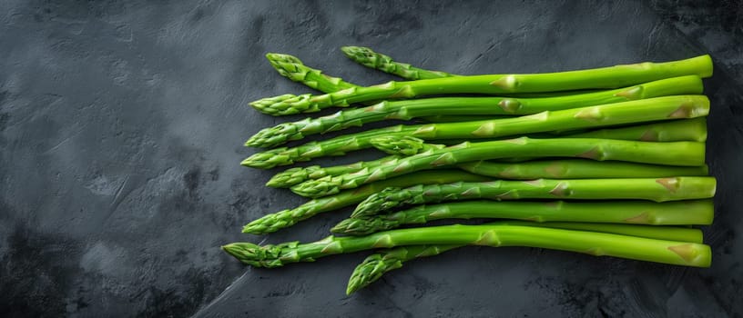 Fresh Green Asparagus on Black Surface. Selective focus.