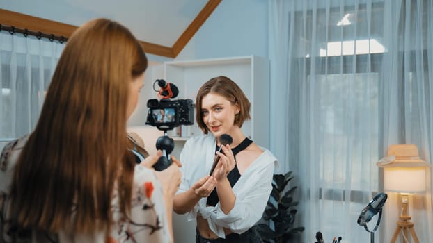 Two influencer partner shoot live streaming vlog video review makeup prim social media or blog. Happy young girl with cosmetics studio lighting for marketing recording session broadcasting online.