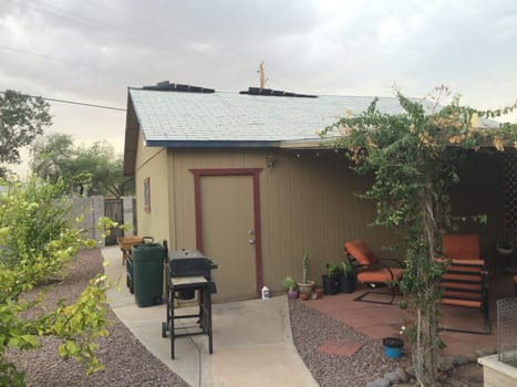 Loose Shingles Blowing on my Roof in a Storm, Garage in Arizona. High quality photo
