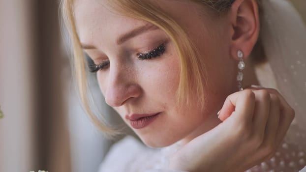 The bride corrects her earring