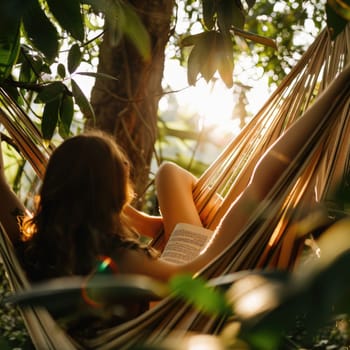 Relaxing in a hammock, surrounded by the tranquil landscape of trees and grass, a person enjoys leisurely reading a book under the shade of a terrestrial plant AIG50