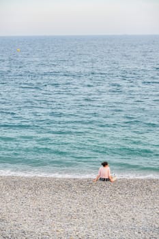 Woman at the beach in Nice, France, near the Promenade des Anglais