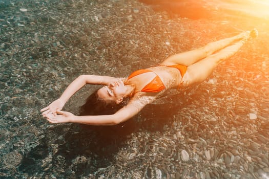 Weight loss and body image concept. Woman with perfect fit body walking confident on beach. Unrecognizable sexy young woman.