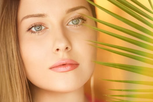 Summer beauty, makeup and skincare, face portrait of beautiful woman with tropical palm tree leaf, natural makeup for cosmetics and fashion look idea