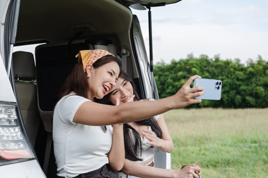 A young lesbian couple enjoyed driving out to see nature and taking picture together..