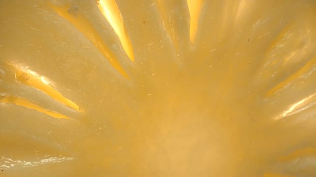The pineapple slice, creating a sense of freshness. A close-up of a sliced pineapple reveals a tropical paradise. Sun-kissed yellow golden flesh with juice, contrasts the rough brown rind. Comestible.