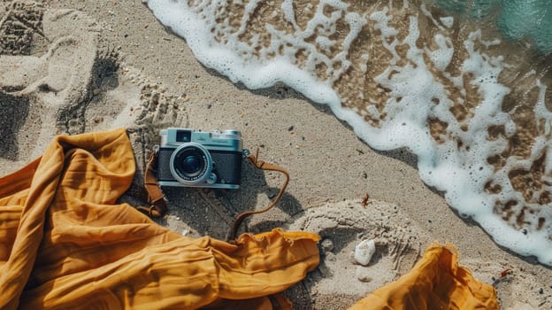 A camera is placed on a blanket at the beach, with the camera lens pointing towards the sea. It appears to be a digital camera, possibly a pointandshoot or mirrorless interchangeablelens camera AIG50