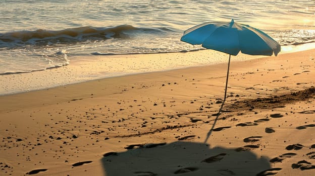 An umbrella rests on the sandy shore of the beach, overlooking the vast expanse of water. Travelers enjoy the scenic landscape as they relax on the shore AIG50