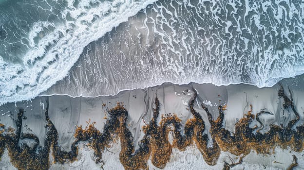 A breathtaking aerial view of waves crashing on a sandy beach, creating a beautiful water and rock landscape art in the world AIG50