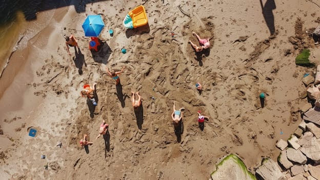 A group of children are leisurely playing in the sand on a beach, creating art and exploring the rock landscape. The beach offers a perfect setting for recreation and adventure AIG50