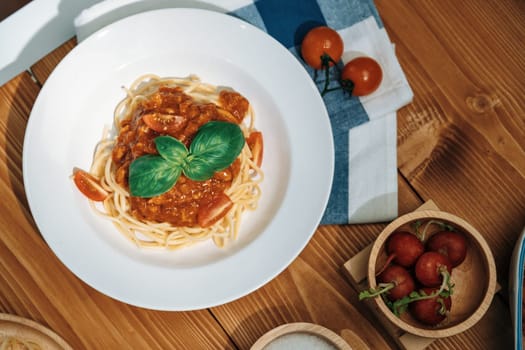 Presented health food's recipe special menu homemade cooking spaghetti with minced meat topped tomato sauce and basil shooting placing elements serving on white plate, side blow of radish. Postulate.