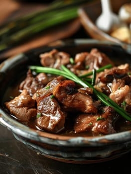 Filipino adobo, a traditional Asian dish, featuring chicken and pork simmered in a savory blend of soy sauce, vinegar, and garlic, served in a ceramic bowl