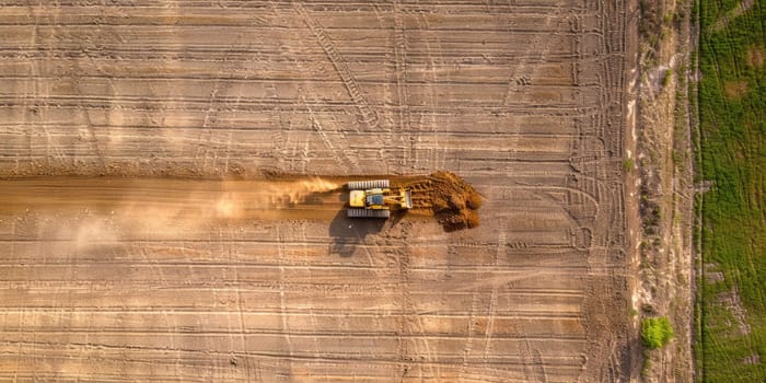 An aerial shot of a tractor plowing a dry field. AIG51A.