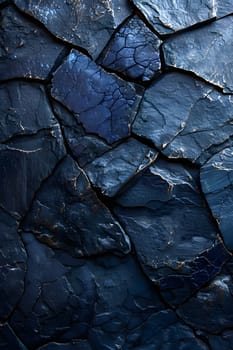 A closeup of a dark blue rock texture resembling cobblestone, with tints and shades of grey and electric blue. The pattern looks like a mix of wood and bedrock, resembling a road surface