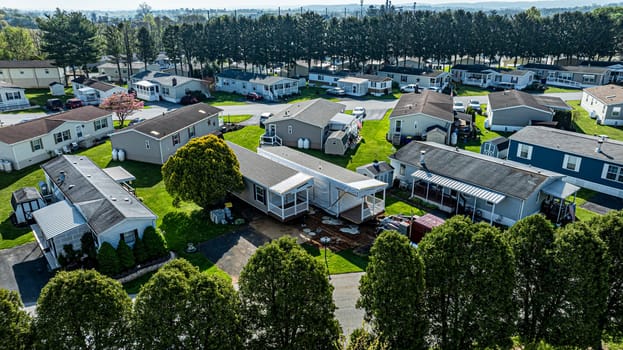 An Aerial View of a Manufactured, Mobile, Prefab Double Wide Home Being Installed in a Lot in a Park