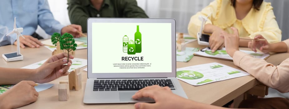 Recycle packaging displayed on laptop at a green business meeting while business team presenting green design. ESG environment social governance and Eco conservative concept. Closeup. Delineation.