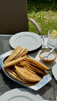 At the picnic, delicious hot chebureks with meat are prepared for tasting. High quality photo