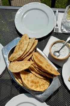 At the picnic, delicious hot chebureks with meat are prepared for tasting. High quality photo