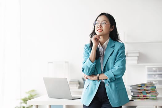 Portrait of young Asian business woman in modern office.
