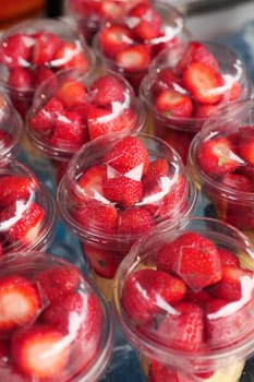 Ripe Red Strawberries in a bowl on table .