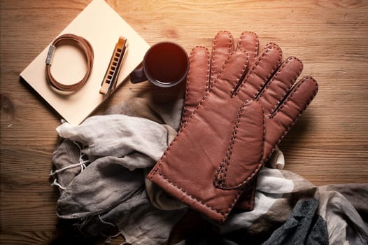 Pair of men's brown leather gloves and other men's accessories.