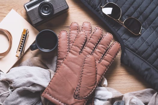 Pair of men's brown leather gloves and other men's accessories.