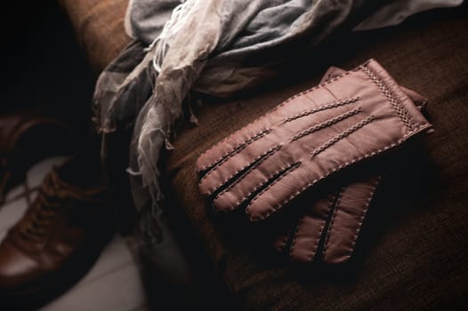 Pair of men's brown leather gloves and other men's accessories.