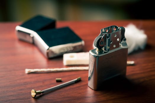 Disassembling of Lighter. Closeup at the flint. Shallow depth of field.