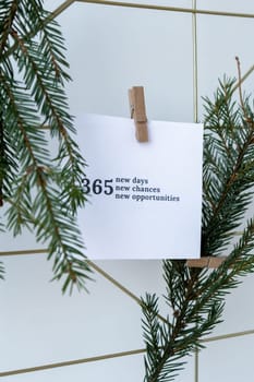 365 NEW DAYS CHANCES OPPORTUNITIES text on white paper note on vision board with Christmas decor. New year aims resolutions. New year New me concept