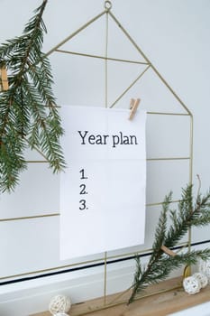 Vision board with YEAR PLAN new year resolutions aims goals on paper note. Preparation for New Year. Concept of planning and setting goals for personal development
