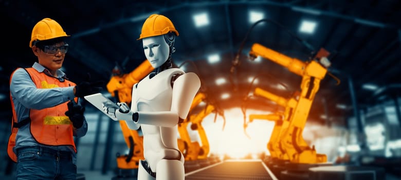 MLP Mechanized industry robot and human worker working together in future factory. Concept of artificial intelligence for industrial revolution and automation manufacturing process.