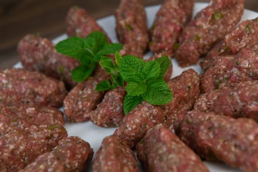 RECIPE FOR LEBANESE KEBBE NAYYHE, RAW MINCED BEEF, MARJORAM, MINT, ONIONS, CRUSHED WHEAT, SEVEN SPICES, CINNAMON, CAYENNE PEPPER. High quality photo