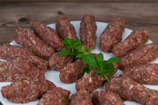 RECIPE FOR LEBANESE KEBBE NAYYHE, RAW MINCED BEEF, MARJORAM, MINT, ONIONS, CRUSHED WHEAT, SEVEN SPICES, CINNAMON, CAYENNE PEPPER. High quality photo