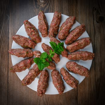 RECIPE FOR LEBANESE KEBBE NAYYHE, RAW MINCED BEEF, MARJORAM, MINT, ONIONS, CRUSHED WHEAT, SEVEN SPICES, CINNAMON, CAYENNE PEPPER. High quality photo