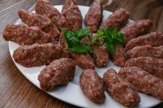 RECIPE FOR LEBANESE KEBBE NAYYHE, RAW MINCED BEEF, MARJORAM, MINT, ONIONS, CRUSHED WHEAT, SEVEN SPICES, CINNAMON, CAYENNE PEPPER. High quality photo