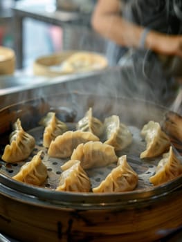 Mongolian buuz, steamed dumplings filled with savory meat, presented on a traditional bamboo steamer tray. This handcrafted dish reflects the unique culinary heritage of Central Asia