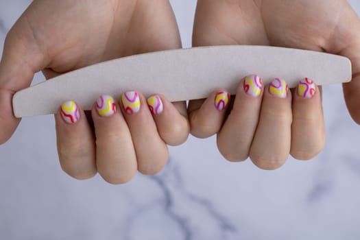 Manicure tools Woman manicured hands, stylish summer colorful nails. Closeup of manicured nails of female hand. Summer style of nail design concept. Beauty treatment.