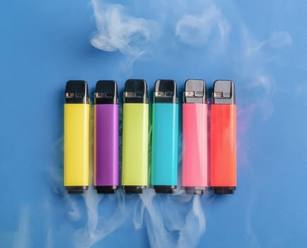 Set of colorful disposable electronic cigarettes on a blue background. The concept of modern smoking. Top view. smoke in the background. High quality photo