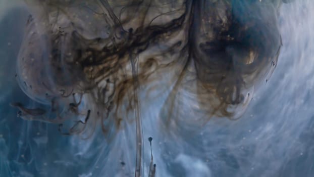 A mesmerizing dance of inky tendrils unfurling through azure waters, evoking a sense of depth and intrigue. white Ink dropped into the water and photographed while in motion.