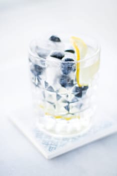 drinks, cocktails and celebration styled concept - cocktail with blueberry ice and lemon, elegant visuals