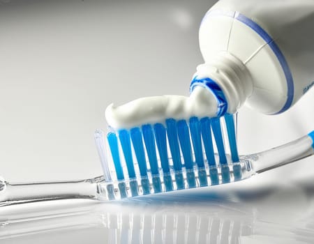 Use a toothbrush to clean partial dentures from replacement teeth.