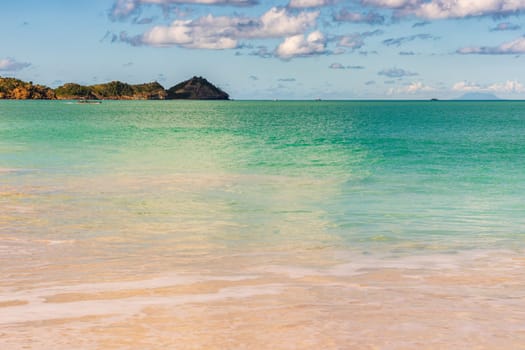 Caribbean beach with white sand, deep blue sky and turquoise water