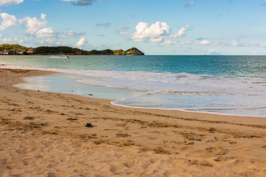 Caribbean beach with white sand, deep blue sky and turquoise water