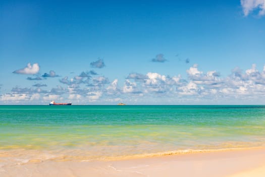 Caribbean beach with white sand, deep blue sky and turquoise water