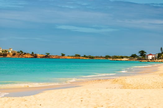 Caribbean beach with white sand, deep blue sky and turquoise water